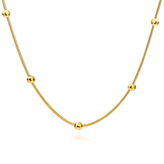Gold snake chain necklace with spaced beaded accents, made from stainless steel with 18K gold PVD plating, waterproof and hypoallergenic.