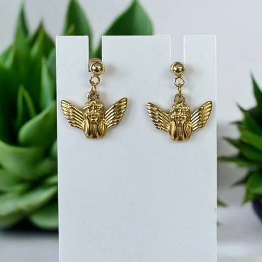 Gold Angel Stud Earrings hanging on earrings stand